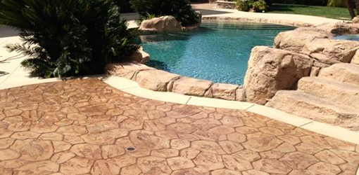 Stamped concrete pool deck and natural stone steps