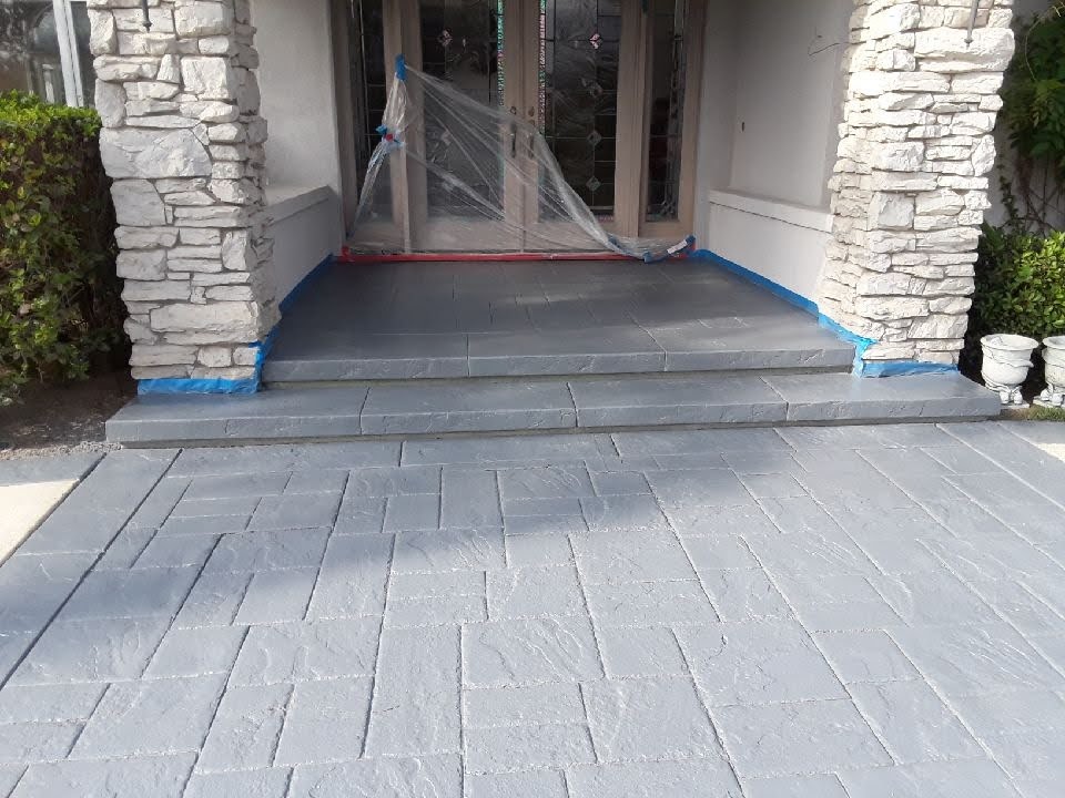 Natural grey stamped concrete staining front entrance